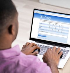 man doing a survey on a laptop